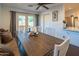 Dining area featuring a wooden table, bench seating, and natural light from the adjacent doors at 1909 E Bethany Home Rd, Phoenix, AZ 85016