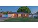Cozy brick home featuring a well-maintained lawn and updated windows at 1909 E Bethany Home Rd, Phoenix, AZ 85016