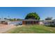 Charming single-story brick home featuring a well-manicured lawn and a cozy front entrance, offering classic curb appeal at 1909 E Bethany Home Rd, Phoenix, AZ 85016