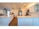 The brightly lit kitchen is features white cabinets and a long kitchen island at 1909 E Bethany Home Rd, Phoenix, AZ 85016