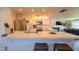 Open concept kitchen with stainless steel appliances, white cabinets, and an island with bar seating at 1909 E Bethany Home Rd, Phoenix, AZ 85016