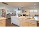 Bright kitchen featuring an island with a sink and modern white cabinetry against a fireplace backdrop at 1909 E Bethany Home Rd, Phoenix, AZ 85016