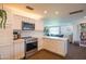 Kitchen with white cabinets, stainless steel appliances, and access to the living room at 1909 E Bethany Home Rd, Phoenix, AZ 85016