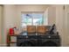 Laundry room with modern appliances, overhead cabinets, and a bright window for natural light at 1909 E Bethany Home Rd, Phoenix, AZ 85016