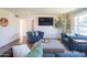 Bright living room boasts modern furnishings, hardwood floors, a large window, and stylish decor for a comfortable living space at 1909 E Bethany Home Rd, Phoenix, AZ 85016