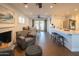 Cozy living room with fireplace, dining area, and kitchen featuring barstool seating at 1909 E Bethany Home Rd, Phoenix, AZ 85016
