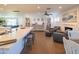 Open-concept living space with kitchen island, fireplace, bookshelves and comfortable seating at 1909 E Bethany Home Rd, Phoenix, AZ 85016