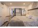 Main bedroom with a closet, natural light, and a decorative headboard and wall art at 1909 E Bethany Home Rd, Phoenix, AZ 85016
