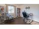 Home office with desk, chair, bookshelves, and a bright window at 1909 E Bethany Home Rd, Phoenix, AZ 85016