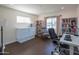 Bright home office featuring a desk, chair, bookshelves, and a Murphy bed at 1909 E Bethany Home Rd, Phoenix, AZ 85016