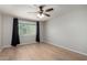 Spacious bedroom with hardwood floors, large window, and ample natural light at 19685 N Star Ridge Dr, Sun City West, AZ 85375
