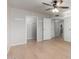 Bright bedroom with hardwood floors featuring multiple closets and doors at 19685 N Star Ridge Dr, Sun City West, AZ 85375