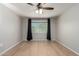 Bedroom featuring hardwood floors, neutral paint and large window at 19685 N Star Ridge Dr, Sun City West, AZ 85375