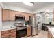 Bright kitchen featuring stainless steel appliances, wooden cabinets and light countertops at 19685 N Star Ridge Dr, Sun City West, AZ 85375