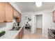 Bright kitchen with modern sink, wood cabinets, and an open view to dining room at 19685 N Star Ridge Dr, Sun City West, AZ 85375
