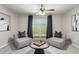 Cozy living room features contemporary decor, neutral color palette, and access to the outdoor patio at 19685 N Star Ridge Dr, Sun City West, AZ 85375