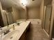 Bright bathroom with a double sink vanity, soaking tub, and separate shower at 19943 N 77Th Ave, Glendale, AZ 85308