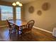 Cozy dining room with hardwood floors, and a traditional wooden table set for four at 19943 N 77Th Ave, Glendale, AZ 85308