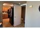 Hallway view that shows a kitchen and powder room at 19943 N 77Th Ave, Glendale, AZ 85308