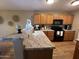 Well-organized kitchen featuring wooden cabinets, granite counters, and modern appliances at 19943 N 77Th Ave, Glendale, AZ 85308