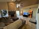 Spacious living room with a fireplace, comfortable seating, and plenty of natural light from sliding glass doors at 19943 N 77Th Ave, Glendale, AZ 85308