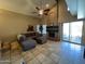 Bright living room with a fireplace, comfortable seating, and seamless access to the outdoors at 19943 N 77Th Ave, Glendale, AZ 85308