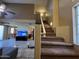 Inviting living room featuring high ceilings, a ceiling fan, and a view into kitchen and dining areas at 19943 N 77Th Ave, Glendale, AZ 85308