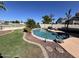 Beautiful backyard pool featuring mature landscaping, stone accents, and a cozy lounge area at 19943 N 77Th Ave, Glendale, AZ 85308