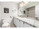 Bathroom featuring granite countertop, white cabinetry, and mirrored wall at 2019 W Lemon Tree Pl # 1185, Chandler, AZ 85224