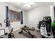 Functional bedroom with exercise equipment and window with blinds and curtains at 2019 W Lemon Tree Pl # 1185, Chandler, AZ 85224