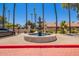 Community area with fountain, palm trees, and view of nearby houses at 2019 W Lemon Tree Pl # 1185, Chandler, AZ 85224