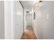 Bright hallway with wood-look flooring and white doors leading to various rooms at 2019 W Lemon Tree Pl # 1185, Chandler, AZ 85224