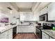 Well-lit kitchen with granite countertops, subway tile backsplash, and stainless steel appliances at 2019 W Lemon Tree Pl # 1185, Chandler, AZ 85224