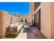 Private outdoor patio featuring stucco walls, flagstone floor, and cushioned seating around a wood coffee table at 2019 W Lemon Tree Pl # 1185, Chandler, AZ 85224