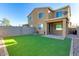 A backyard featuring synthetic grass, a covered patio, and a privacy wall around the perimeter at 2254 E University Dr # 4, Mesa, AZ 85213