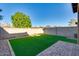 A backyard featuring a stone walkway, synthetic grass, and a privacy wall around the perimeter at 2254 E University Dr # 4, Mesa, AZ 85213