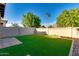 This backyard features artificial turf, pavers, and a block wall for privacy at 2254 E University Dr # 4, Mesa, AZ 85213