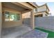 A covered backyard patio featuring a stone walkway, and synthetic grass for easy maintenance at 2254 E University Dr # 4, Mesa, AZ 85213