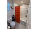 Bright bathroom showcasing a bathtub with tiled surround and an orange ruffled shower curtain at 2254 E University Dr # 4, Mesa, AZ 85213