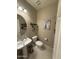Charming half bathroom featuring pedestal sink, tile floor, and nautical-themed decorations at 2254 E University Dr # 4, Mesa, AZ 85213