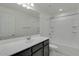 Bright bathroom featuring a sink and vanity, combined shower-tub, toilet, and a large mirror at 2254 E University Dr # 4, Mesa, AZ 85213