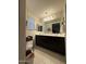 Bathroom featuring a double vanity, large mirrors, and neutral tile flooring at 2254 E University Dr # 4, Mesa, AZ 85213