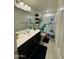 Bathroom features a modern vanity, a decorative mirror, and a fun dinosaur themed shower curtain at 2254 E University Dr # 4, Mesa, AZ 85213