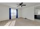 Carpeted bedroom with natural light, ceiling fan, and an ensuite bathroom at 2254 E University Dr # 4, Mesa, AZ 85213