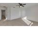 Sunlit carpeted bedroom featuring a ceiling fan and ample space at 2254 E University Dr # 4, Mesa, AZ 85213