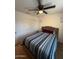 Bedroom featuring striped bedspread, ceiling fan, and large closet at 2254 E University Dr # 4, Mesa, AZ 85213