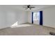 Spacious bedroom featuring a ceiling fan and natural light from a window with blue curtains at 2254 E University Dr # 4, Mesa, AZ 85213