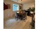 Cozy dining room featuring a wood table with four chairs, illuminated by a stylish pendant light at 2254 E University Dr # 4, Mesa, AZ 85213