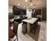 Bright, open kitchen showcasing an island with bar seating, granite countertops, and stainless steel appliances at 2254 E University Dr # 4, Mesa, AZ 85213