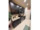 Well-lit kitchen featuring granite countertops, stainless steel appliances, and sleek, dark cabinetry at 2254 E University Dr # 4, Mesa, AZ 85213